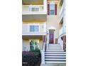 Three-story house with brick and siding, featuring a front porch and stairs at 10420 Sablewood Dr # 115, Raleigh, NC 27617