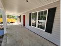 Covered front porch with red door and black shutters at 910 West St, Smithfield, NC 27577