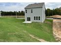 Gray house with sliding glass doors and small patio at 87 Furley St., Homesite 112, Sanford, NC 27330
