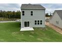 Gray house with sliding glass doors and small patio at 87 Furley St., Homesite 112, Sanford, NC 27330