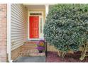 Inviting front entrance with red door, brick steps, and landscaping at 65 Applegate Dr, Franklinton, NC 27525