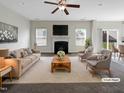 Virtually staged living room with fireplace and access to backyard at 9 Oxmoor Dr, Durham, NC 27703