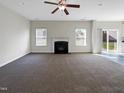 Spacious living room featuring a fireplace and carpet flooring at 9 Oxmoor Dr, Durham, NC 27703