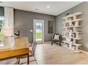 Bright home office with a built-in shelving unit and wood desk at 4202 Bryson Dr # 54, Durham, NC 27703