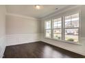 Formal dining room with dark hardwood floors and a wall of windows at 169 Sage Ln # 012, Four Oaks, NC 27524