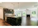 Open concept kitchen with large island, granite countertops, and dark cabinetry at 169 Sage Ln # 012, Four Oaks, NC 27524