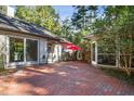 Brick patio with seating area, umbrella, and access to the house at 675 Whitehurst, Pittsboro, NC 27312