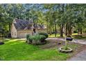 House exterior featuring a two-story home with a stone facade and attached garage at 10737 E Bridgford Dr, Cary, NC 27518