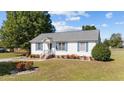 Front view of a white ranch home with gray roof and landscaping at 49 Baysprings Ct, Willow Springs, NC 27592