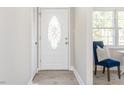 Bright entryway with white door and hardwood floors at 2050 Ridgedell Dr, Elon, NC 27244