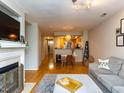 Open living room with hardwood floors, fireplace, and comfortable seating at 1001 Hillsborough St # 304, Raleigh, NC 27603