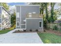 Rear view of a modern two-story home with gray siding and a deck at 112 N Guthrie Ave # A, Durham, NC 27703