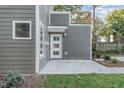 Side view of a modern two-story home with gray siding and a patio at 112 N Guthrie Ave # A, Durham, NC 27703