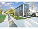 Gray modern home with a concrete driveway and landscaping at 112 N Guthrie Ave # C, Durham, NC 27703