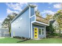 Two-story modern home with blue siding and yellow door at 112 N Guthrie Ave, Durham, NC 27703