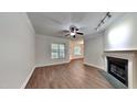 Living room with fireplace, wood-look floors, and ceiling fan at 1414 Arborgate Cir, Chapel Hill, NC 27514