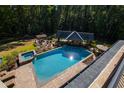 Large inground pool with spa and outdoor entertainment area at 2117 Blue Haven Ct, Wake Forest, NC 27587