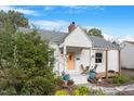 Charming white brick home with a yellow door and landscaped yard at 113 Higbee St, Durham, NC 27704