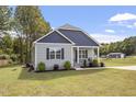 Exterior view of the house with a shed and playset in the background at 619 Tripp Rd, Lillington, NC 27546