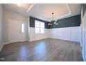 Bright dining room with hardwood floors, wainscoting, and a chandelier at 49 Abingdon Farms Dr, Selma, NC 27576