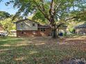 Large backyard with mature trees and spacious grassy area at 3704 Huntleigh Dr, Raleigh, NC 27604