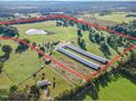 Aerial view of property showing farm buildings and a pond at 205 Shelby Ln, Siler City, NC 27344