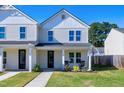 Two-story white house with front porch and rocking chairs at 3010 Garner Rd # 101, Raleigh, NC 27610