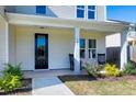 Front porch with rocking chairs and view of front yard at 3010 Garner Rd # 101, Raleigh, NC 27610