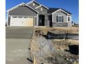 Gray siding two-story house with stone accents and a two-car garage at 202 Bering Cir, Angier, NC 27501