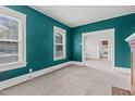Spacious living room with teal walls, carpeting, and fireplace at 810 E Edenton St, Raleigh, NC 27601