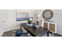 Modern home office with dark wood desk and stylish decor at 385 Swift Creek Farm Ln, Clayton, NC 27520