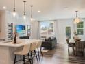 Open concept kitchen with island, white cabinets, and wine rack at 304 Deercroft Dr, Apex, NC 27539