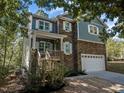 Two-story home with stone and siding exterior, and a two-car garage at 117 Waterville St, Raleigh, NC 27603