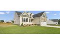 Beige house exterior with stone accents and landscaping at 45 S Harper Faith Way, Benson, NC 27504