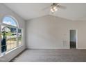 Spacious living room with vaulted ceiling and large window at 6849 Coventry Ridge Rd, Raleigh, NC 27616