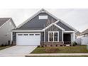 Gray house with white garage door and landscaping at 1724 Red Elm Lane, Homesite 76, Fuquay Varina, NC 27526