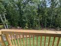 Wooden deck overlooking a fenced backyard and wooded area at 4738 Cypress Tree Ln, Raleigh, NC 27612