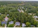 Aerial view showing a residential neighborhood with houses nestled among lush green trees at 414 Englewood Dr, Chapel Hill, NC 27514