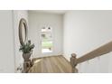 Bright and airy entryway with wood floors and modern console table at 708 Portia Way, Homesite 13, Morrisville, NC 27560