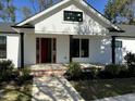 Front porch with red door and brick steps leading to the entrance at 3120 Nc Hwy 210, Smithfield, NC 27577