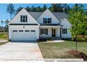Beautiful two-story farmhouse with a large front yard at 3806 River Mill Ln, Franklinton, NC 27525