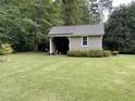 Detached shed with a single door and window, in the backyard at 936 Elbridge Dr, Raleigh, NC 27603