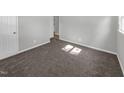 Bright bedroom with neutral carpeting and walls at 112 Bradsher Rd, Roxboro, NC 27574
