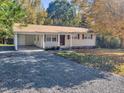 Ranch home with gravel driveway and carport at 112 Bradsher Rd, Roxboro, NC 27574