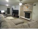 Living room with sectional sofa, fireplace, and large TV at 812 Siler City Glendon Rd, Siler City, NC 27344