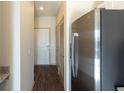 Hallway with view into kitchen and stainless steel refrigerator at 2326 Gathering Sq Ct, Fuquay Varina, NC 27526