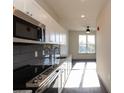 Modern kitchen with stainless steel appliances and granite countertops at 2326 Gathering Sq Ct, Fuquay Varina, NC 27526