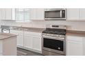 Modern kitchen with stainless steel appliances and grey countertops at 1482 Rhodes Pond St, Wendell, NC 27591