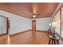 Bright living room with hardwood floors, wood ceiling, and a fireplace at 435 Tant Rd, Zebulon, NC 27597