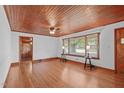 Living room with hardwood floors, wood ceiling, and large window at 435 Tant Rd, Zebulon, NC 27597